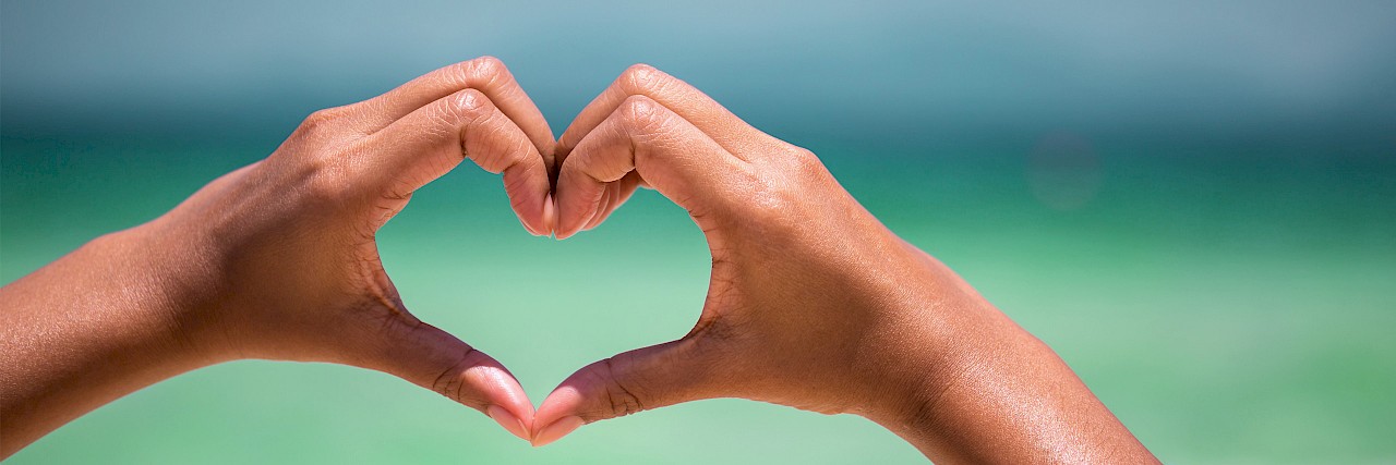 Photo of two hands making a heart to show behavioral health care provided by licensed clinical social workers, marriage and family counselors, and clinical social workers.