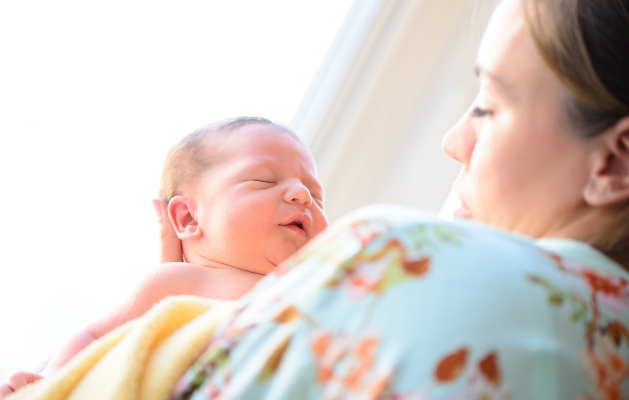 Photo of a mother and child after working with a certified midwife for a healthy delivery.