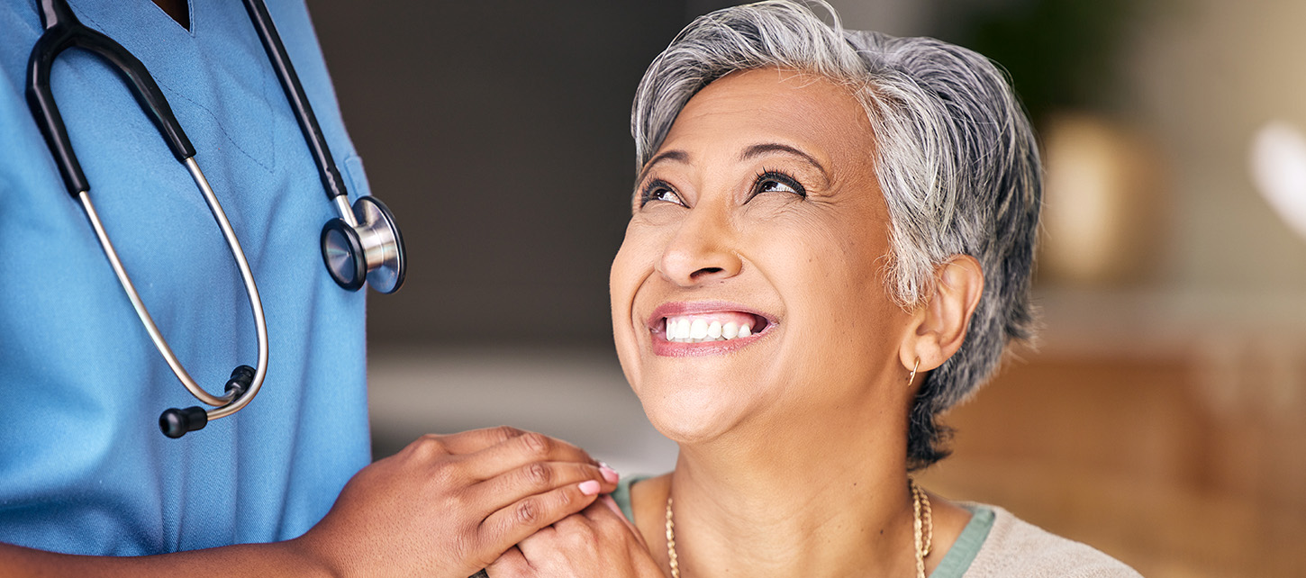 Happy woman smiling at a nurse.